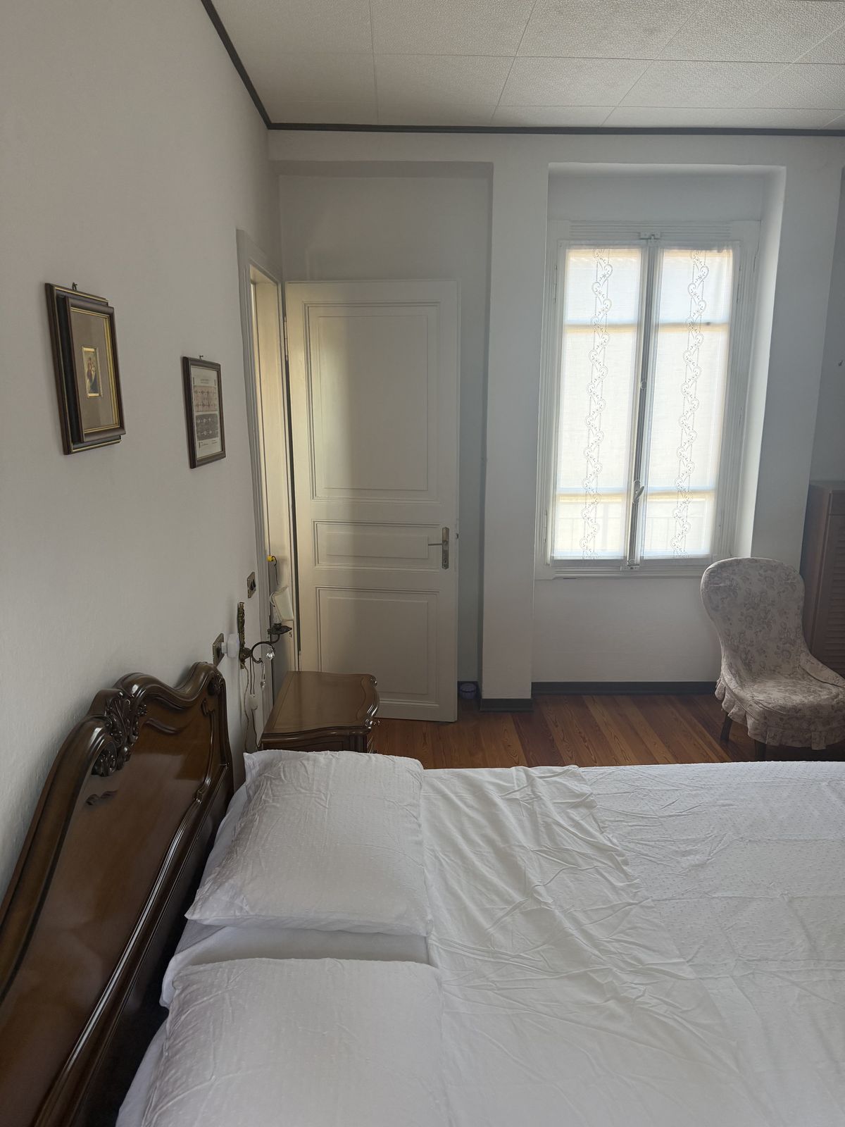 Grote slaapkamer met raam en fauteuil